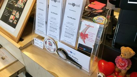A row of menus are displayed on a countertop.