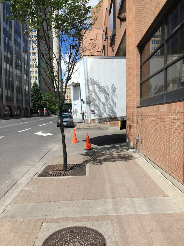 Truck parked across sidewalk.